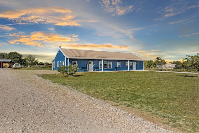 ranch-style house featuring a porch and a yard