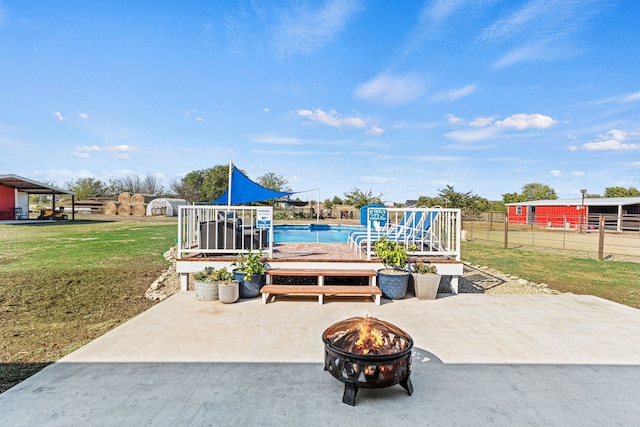 view of patio / terrace with a fire pit and a pool side deck