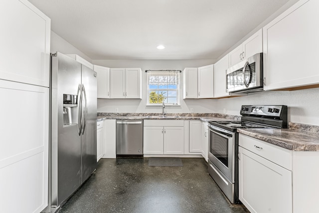 kitchen with white cabinets, appliances with stainless steel finishes, and sink