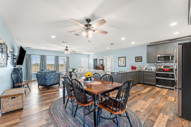 dining area with dark hardwood / wood-style floors and ceiling fan