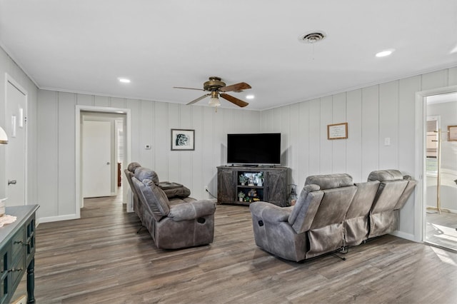 living room featuring ceiling fan and wood-type flooring