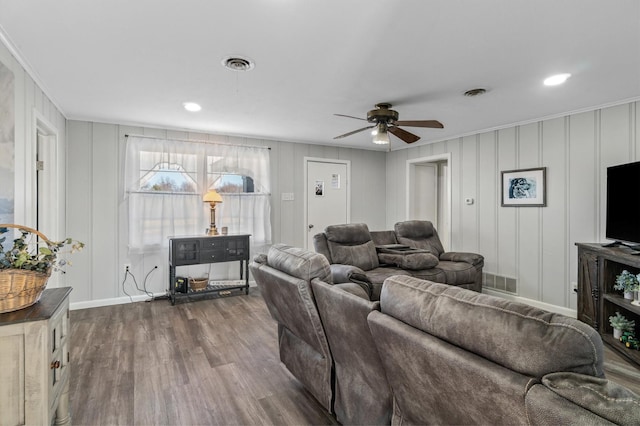 living room featuring hardwood / wood-style flooring, ceiling fan, and ornamental molding