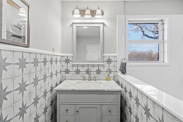 bathroom with vanity and tile walls