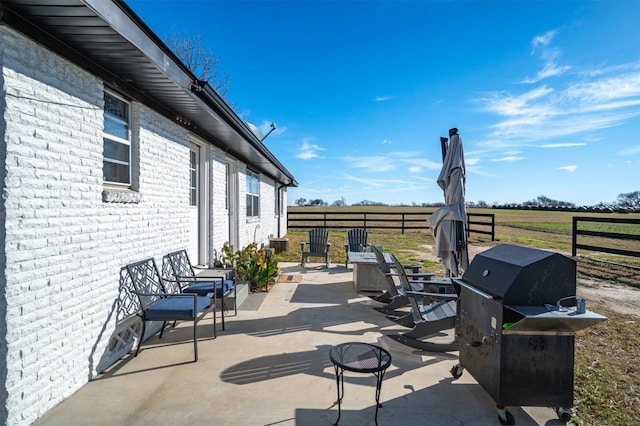 view of patio featuring a rural view and a grill