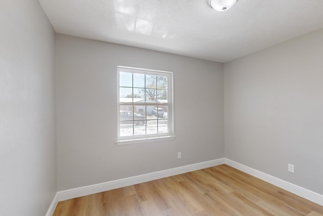 unfurnished room with light hardwood / wood-style floors