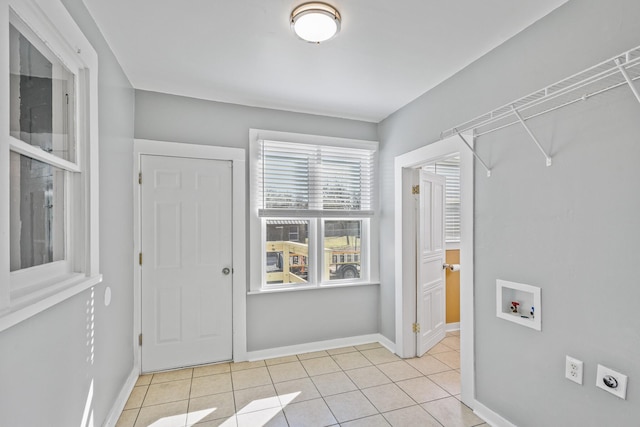 laundry area featuring hookup for a washing machine, electric dryer hookup, and light tile patterned floors