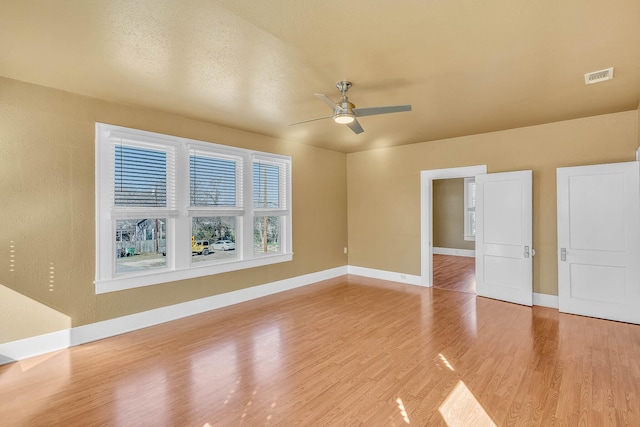 unfurnished room featuring hardwood / wood-style flooring, a textured ceiling, and ceiling fan