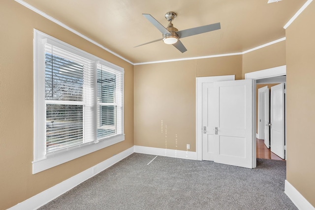 unfurnished bedroom with crown molding, ceiling fan, and carpet flooring