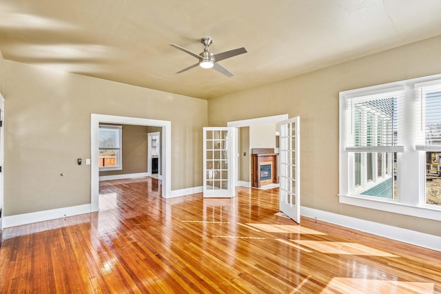 unfurnished room with french doors, ceiling fan, and hardwood / wood-style floors