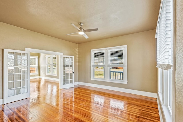 unfurnished sunroom with french doors and ceiling fan