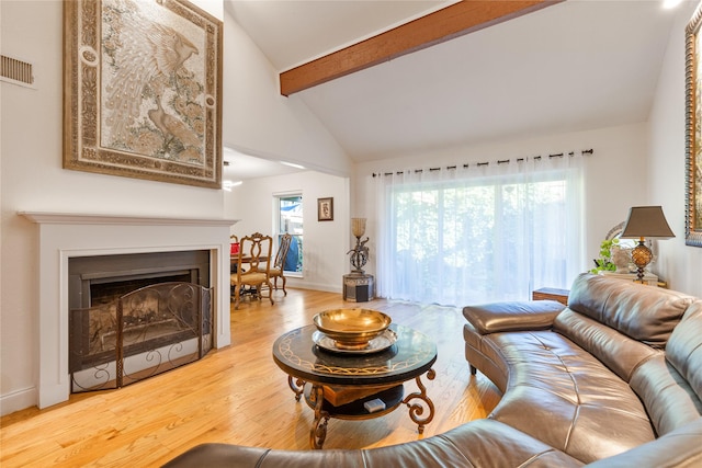 living room featuring hardwood / wood-style floors and lofted ceiling with beams