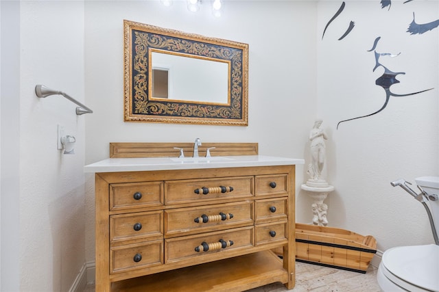 bathroom featuring toilet and vanity