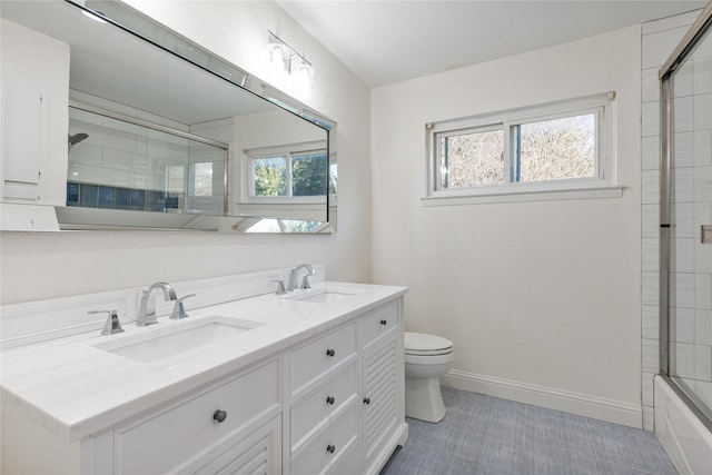 full bathroom with toilet, tile patterned floors, a wealth of natural light, and vanity