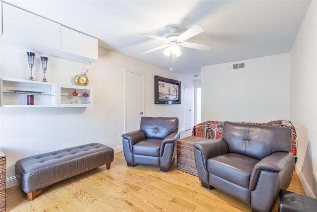 living area with light wood-type flooring and ceiling fan