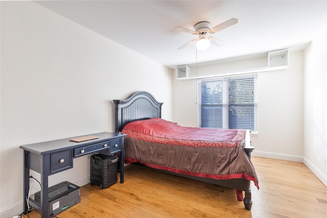 bedroom with hardwood / wood-style floors and ceiling fan