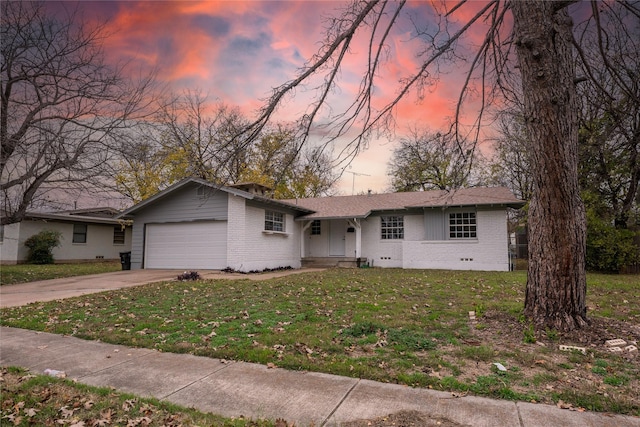 ranch-style house with a yard and a garage