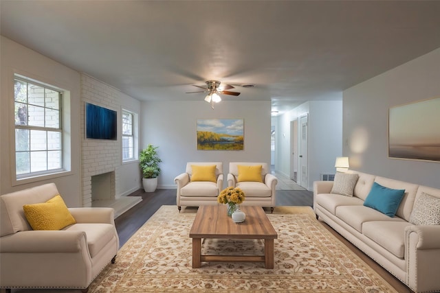 living room with ceiling fan, hardwood / wood-style floors, and a brick fireplace