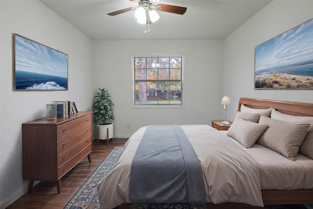 bedroom with ceiling fan and dark hardwood / wood-style flooring