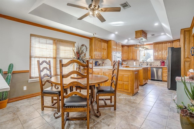 dining room featuring light tile patterned floors, a tray ceiling, visible vents, and baseboards