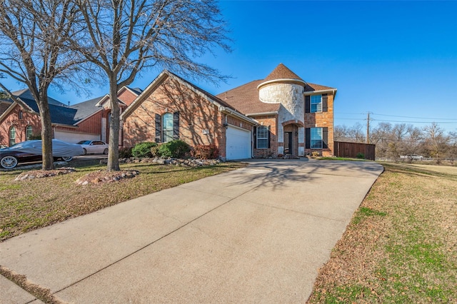 view of property featuring a front yard and a garage