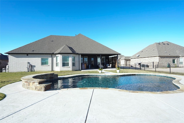 view of pool with a lawn and a patio