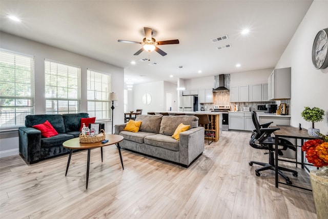 living room featuring light hardwood / wood-style floors and ceiling fan