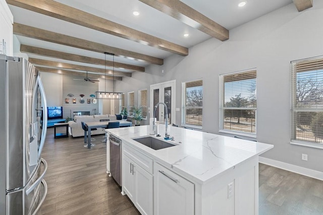 kitchen featuring sink, white cabinetry, a center island with sink, and appliances with stainless steel finishes