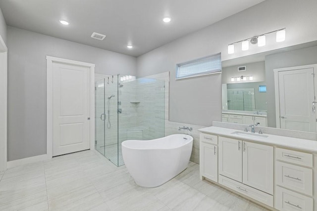 bathroom with vanity and separate shower and tub