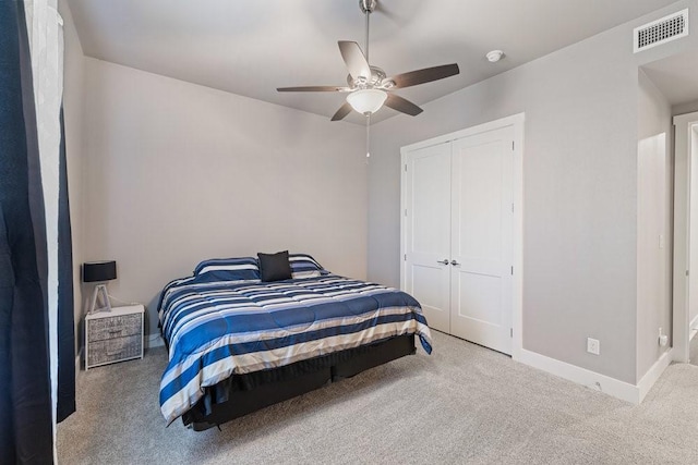 bedroom featuring a closet, ceiling fan, and light carpet