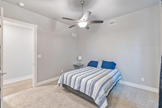 bedroom with ceiling fan and light colored carpet