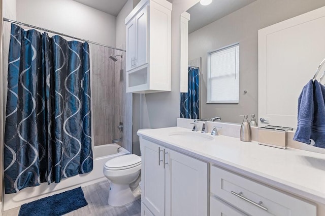 full bathroom featuring toilet, hardwood / wood-style flooring, vanity, and shower / tub combo with curtain