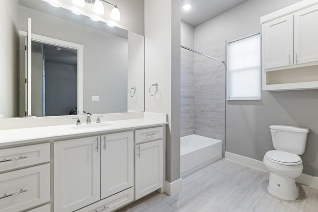 full bathroom with toilet, tiled shower / bath combo, and vanity