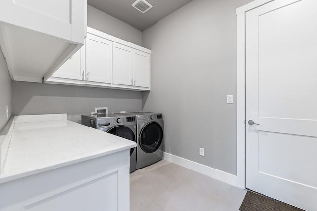 laundry room with cabinets and independent washer and dryer