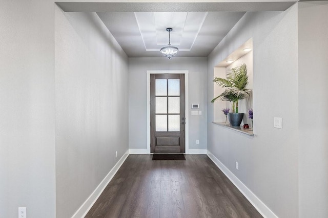 doorway featuring dark hardwood / wood-style floors and a chandelier