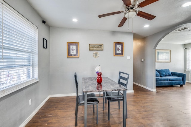 dining room with ceiling fan and dark hardwood / wood-style flooring