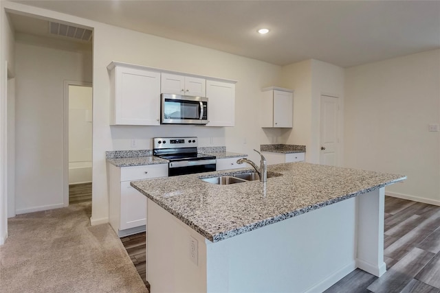 kitchen with white cabinetry, sink, a kitchen island with sink, and appliances with stainless steel finishes