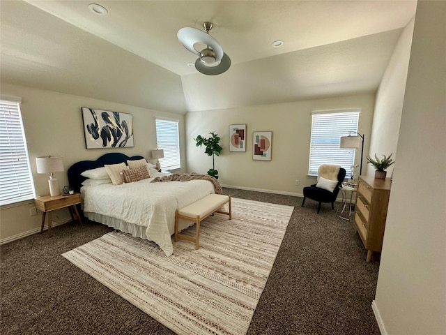 carpeted bedroom with ceiling fan, multiple windows, and vaulted ceiling