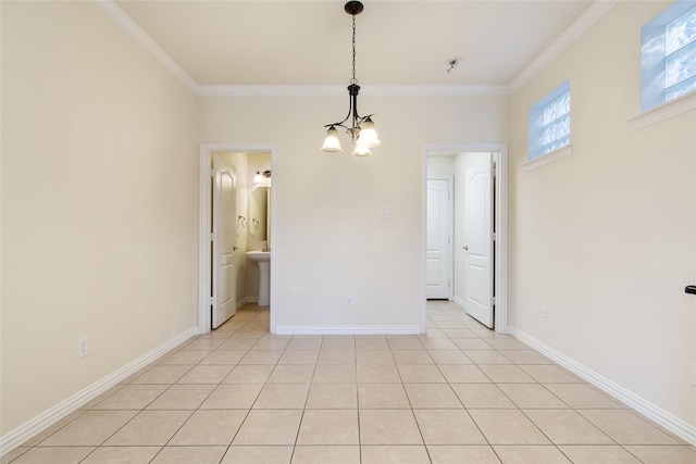 tiled spare room with crown molding and a notable chandelier