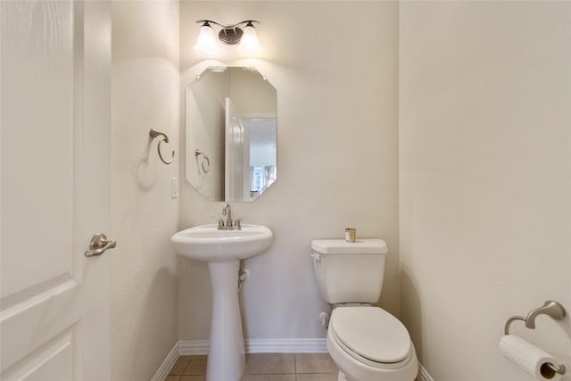 bathroom with tile patterned flooring, toilet, and sink