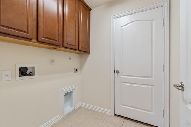 laundry room with gas dryer hookup, cabinets, hookup for a washing machine, light tile patterned floors, and hookup for an electric dryer