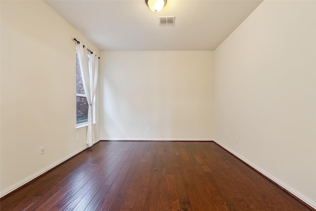 unfurnished room with dark hardwood / wood-style flooring