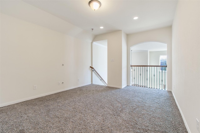 unfurnished room with carpet flooring and lofted ceiling