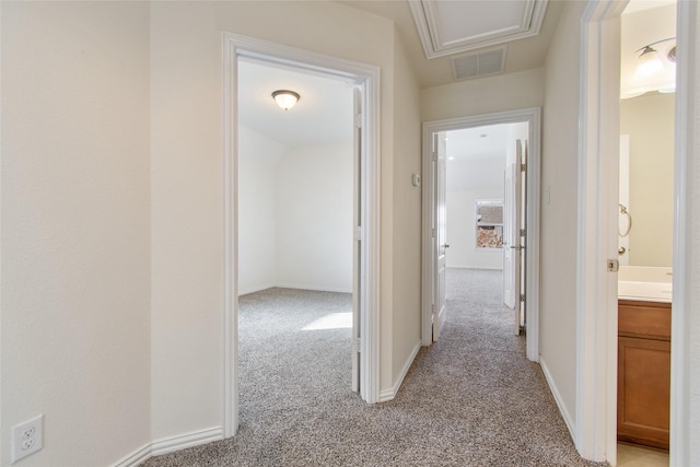 hall featuring light colored carpet