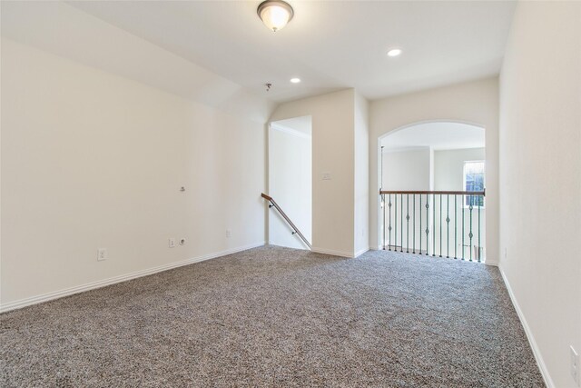 empty room featuring carpet floors, ceiling fan, and lofted ceiling