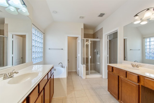 bathroom featuring tile patterned flooring, vanity, lofted ceiling, and plus walk in shower