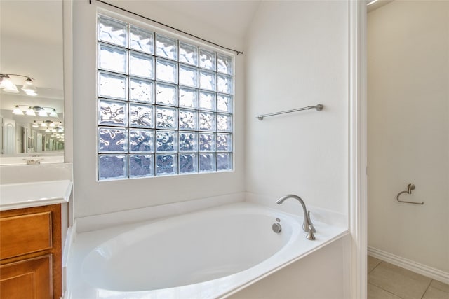 bathroom featuring tile patterned floors, vanity, and a bath