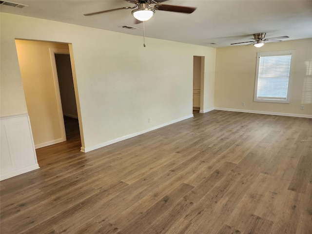 spare room with ceiling fan and wood-type flooring