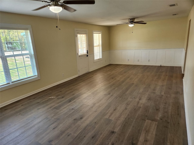 unfurnished room featuring dark hardwood / wood-style floors, a healthy amount of sunlight, and ceiling fan