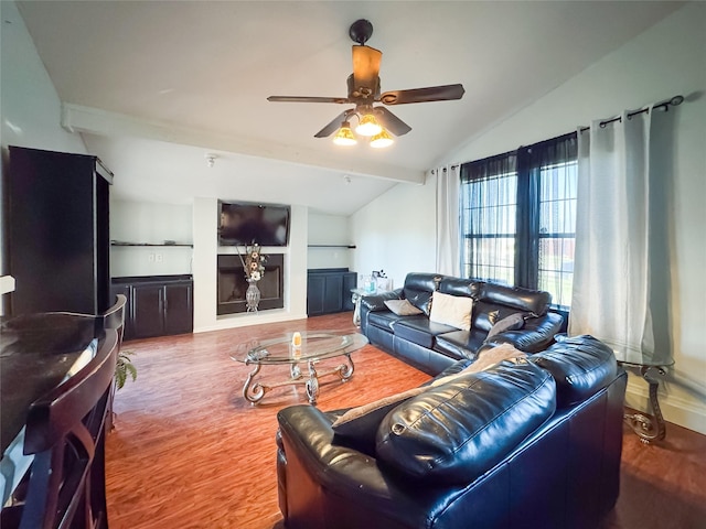 living room with ceiling fan, lofted ceiling, and hardwood / wood-style flooring