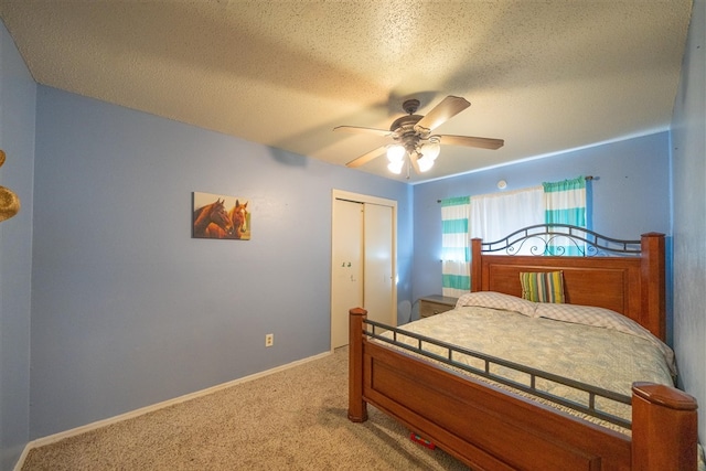 bedroom with ceiling fan, carpet floors, a textured ceiling, and a closet